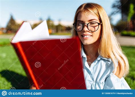 Portrait Of A Cheerful Beautiful Student Girl Sitting Outdoors O Stock