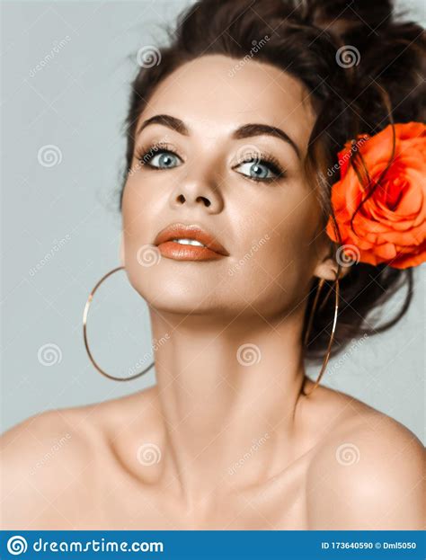 Portrait Of Young Beautiful Brunette Naked Woman In Circle Earrings