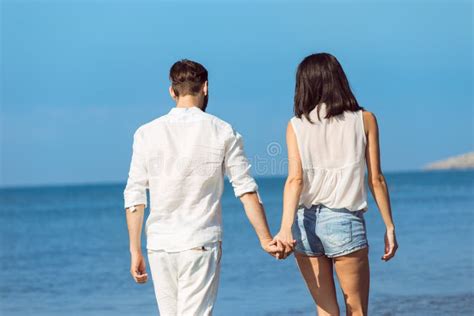 Couple Walking On Beach Young Happy Interracial Couple Walking On Beach Smiling Holding Around