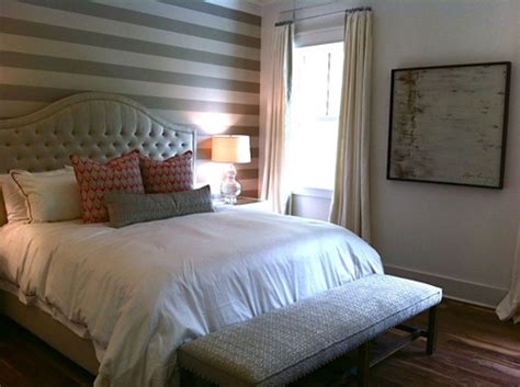 A dark bedroom refreshed with a monochromatic graphic accent wall and mustard stools upholstered with fabric. The 9 Best Bedroom Accents