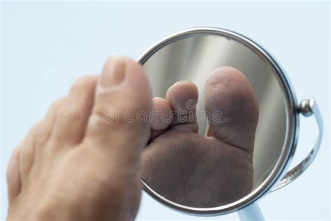 Person Looking At The Sole Of The Foot In A Mirror Stock Image Image