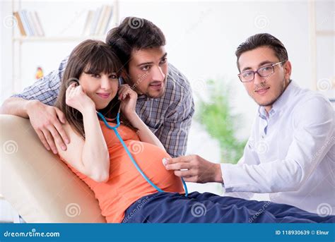 The Pregnant Woman With Her Husband Visiting The Doctor In Clinic Stock Image Image Of