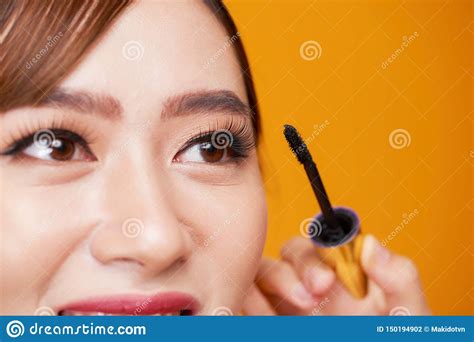 Beautiful Woman Applying Mascara On Her Eyelashes Stock Photo Image