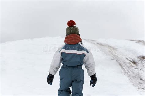 Back View The Child Walks In The Winter On The Street Boy Walks On