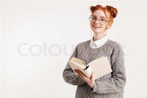 Portrait Of An Excited Young School Nerd Girl Holding Book Stock Image Colourbox