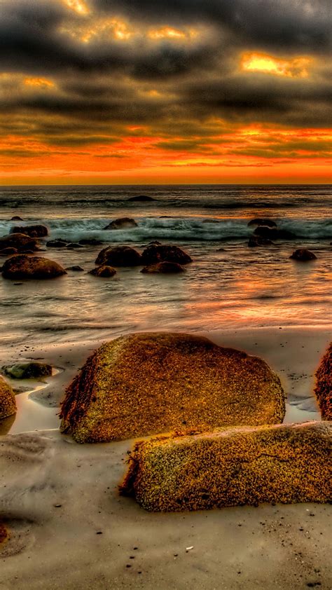 Brown Rocks In Front Of Seashore With Black And Red Clouds 4k Hd Nature