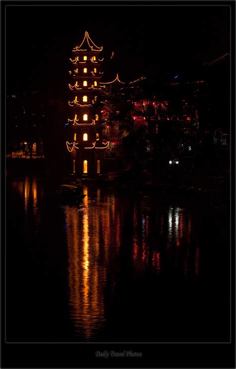 String Sparkle The Nighttime Reflection Of A Pagoda In The Li River