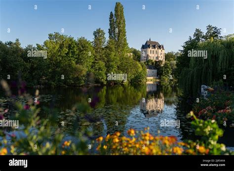 Castle Raoul With Yellow Flower And Reflection In Water In Chateauroux