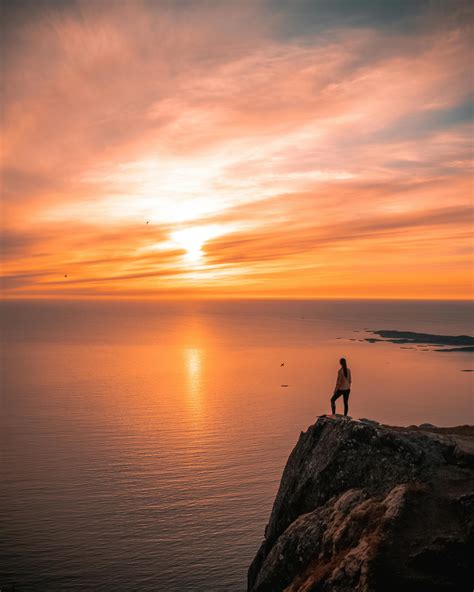 Man Standing On Cliff During Sunset · Free Stock Photo