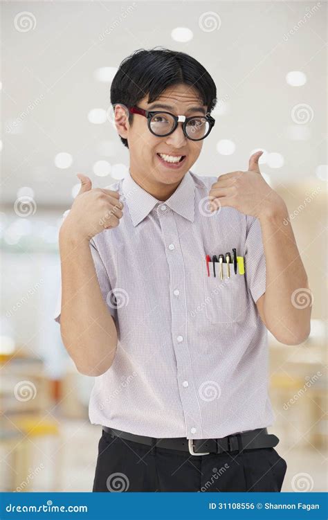 Nerdy Man With Glasses Giving Thumbs Up Looking At Camera Stock Photo