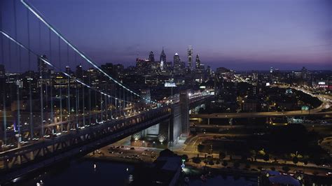 5K stock footage aerial video flying by the Benjamin Franklin Bridge and approach Downtown ...
