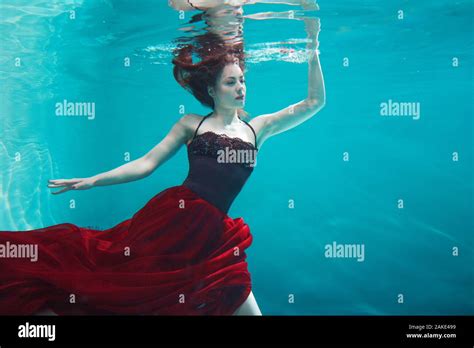 Beautiful Girl In A Red Dress Swims Under Water Amazing Underwater