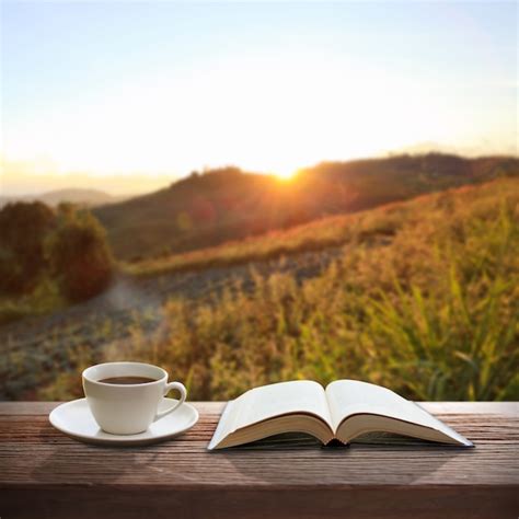 Cup Of Coffee And A Book On A Wooden Table Premium Photo