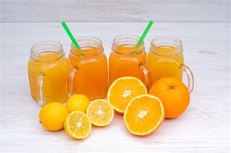 Free Photo Delicious Orange And Lemon Juice On White Wooden Table