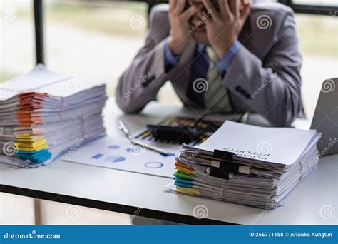 Tired Asian Young Businessman With Stacks Of Paperwork Busy Work