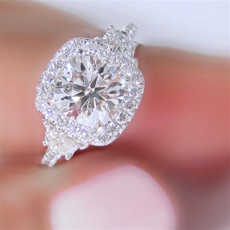 three stone engagement rings and halos aren t often seen together this gabriel ring was