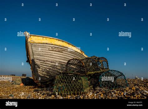 An Abandoned And Derelict Boat On The Beach At Dungeness In Kent Stock