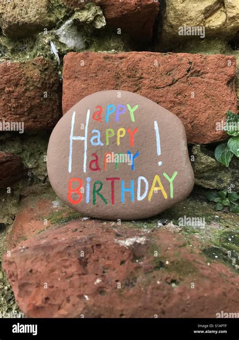 Happy Happy Happy Birthday Carved And Colored On A Stone Stock Photo