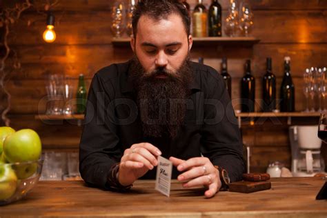 Bearded Hipster Bartender Playing With His Trick Cards Stock Image