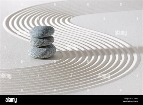 Japanese Zen Garden In White Sand With Stacked Stones Stock Photo Alamy