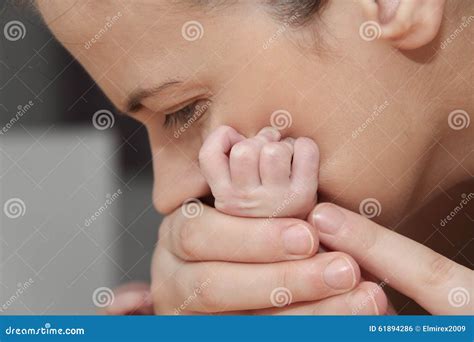 Mother And Her Newborn Baby Parent Holding Newborns Hands Stock Photo