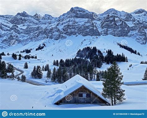 Idyllic Swiss Alpine Mountain Huts Dressed In Winter Clothes And In A