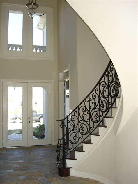 This Staircase Features Wrought Iron Spiraled Panels The Intricately