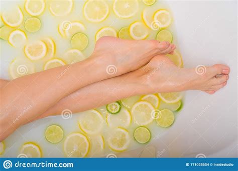 Unrecognizable Woman Takes A Milk Bath With Lemons And Limes Citrus