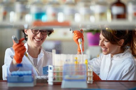 A Young Female Students Enjoy While Pipetting In A Laboratory Science