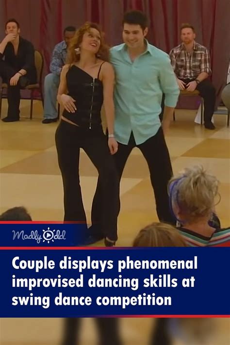 Two People Are Dancing On The Dance Floor In Front Of An Audience With