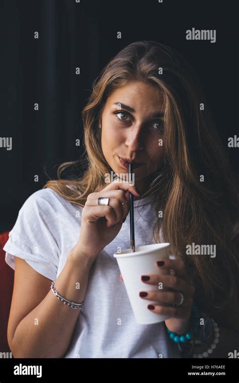 Woman Drinking Coffee Through A Straw Stock Photo Alamy