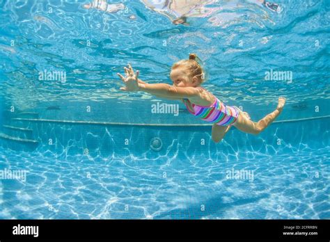 Funny Child Learning Swimming Dive In Blue Pool With Fun Jumping