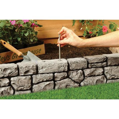 The spikes pierce through weed fabric easily and help secure the barrier. Dalen Products 6 in. x 10 ft. StoneWall Border-E4-10GY ...