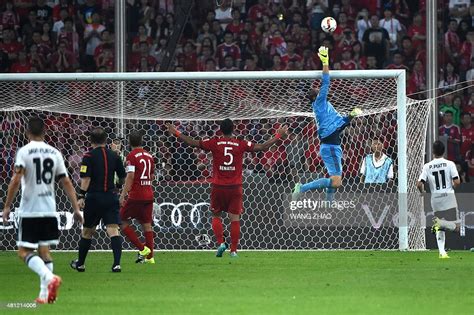 But neuer came to the rescue by diving low. Bayern Munich's goalkeeper Manuel Neuer dives for a ball ...