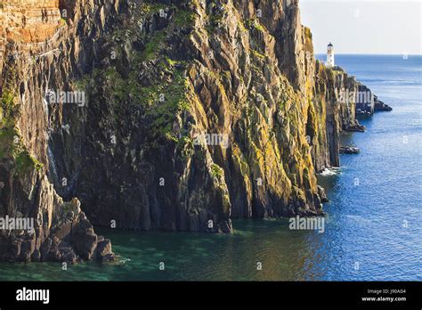 A Look At Lighthouse On The Cliffs Of Neist Point Rugged And Rocky