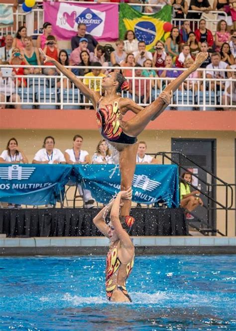 Two Women Are Doing Tricks In The Water