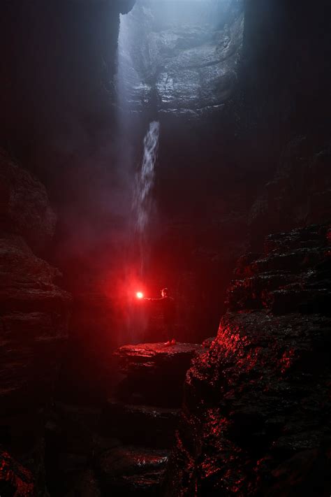 A Dark Cave With A Waterfall Coming Out Of It Photo Free Usa Image On