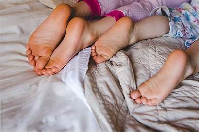 Feet Bare Lying Bed Pajamas Stocksy
