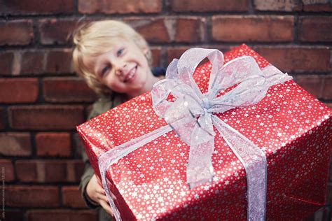 Happy Smiling Little Boy Carrying A Large Christmas Present Christmas