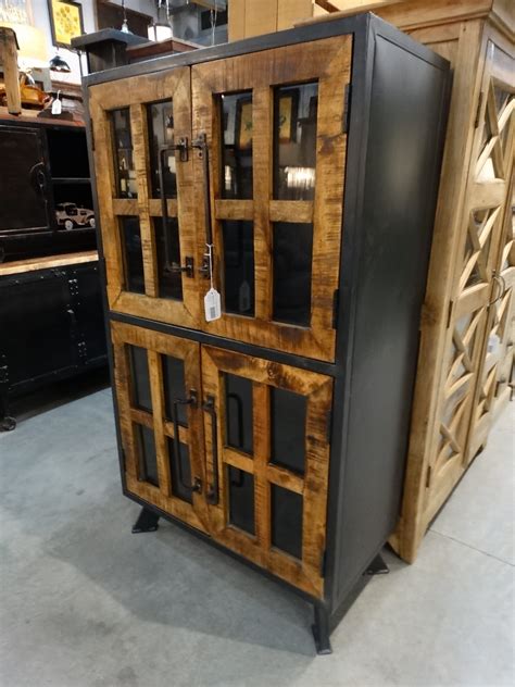 Vertical Metal Cabinet With Glass Doors Has A Rustic Industrial Flair