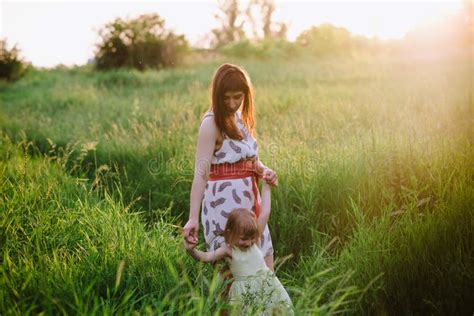 Mom And Daughter Dancing In Nature Together In Sunset Light Stock Image