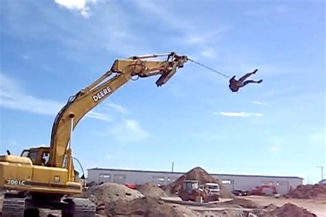 Video Geniuses Wrap Themselves In Rope Let An Excavator Sling Them