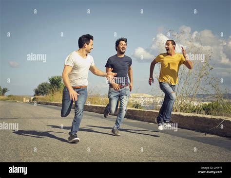 3 Men Running Outside Stock Photo Alamy