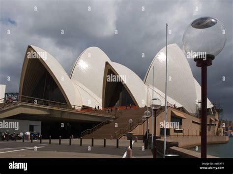 Dramatic View Of The Opera House Shells Gleaming Sunlit Against A Grey