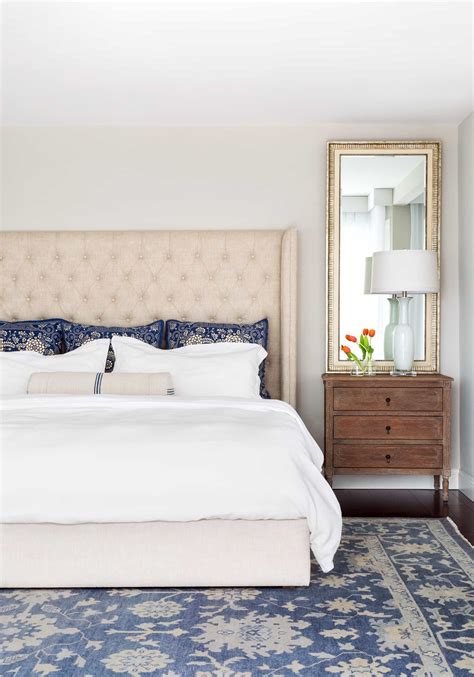 Traditional Bedroom With Upholstered Headboard And Antique Wood
