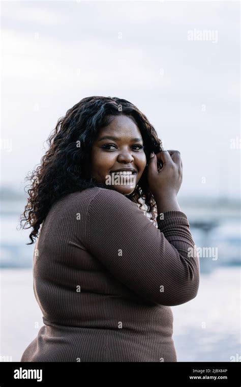 Vertical Confident Black Haired Afro American Plump Woman Look Camera