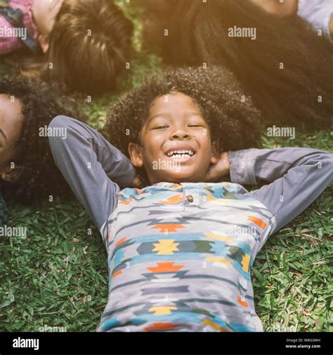 Happy Children African American Kids Laying On Grass In Park Stock