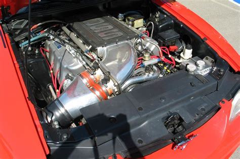 The Engine Compartment Of An Orange Sports Car