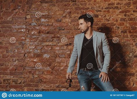 Portrait Of A Handsome Stylish Man Posing In Loft Studio Interior