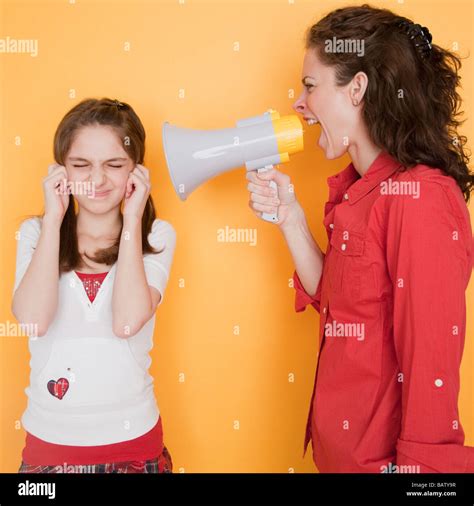 Mother Yelling At Daughter 10 11 Years Through Megaphone Stock Photo
